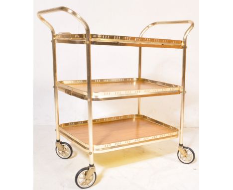 A retro vintage mid 20th century butlers hostess serving cocktail trolley having a three tier of Formica trays set within a t