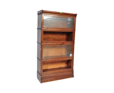 An original early 20th Century Globe Wernicke stacking modular barrister / lawyers bookcase having sliding lift up glass door