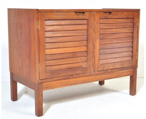 A retro vintage mid 20th Century teak wood cabinet. Of rectangular form with two slatted front doors with shelves to interior