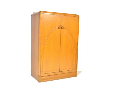 A vintage 20th Century Art Deco circa 1930s tallboy wardrobe cabinet. Rectangular form with stepped top, twin doors opening t