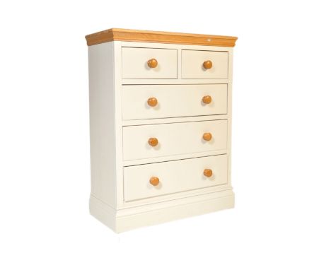 Contemporary oak and white painted chest of drawers. Raised on a deep plinth base having short and deep 2 over 3 configuratio