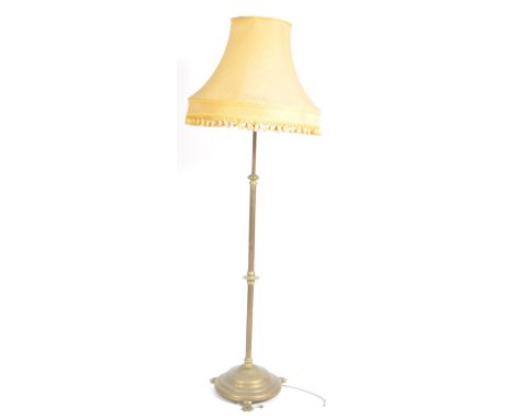 A 19th century Victorian brass hairy paw feet floor standing standard lamp. Raised&nbsp; on a stepped circular terraced base 