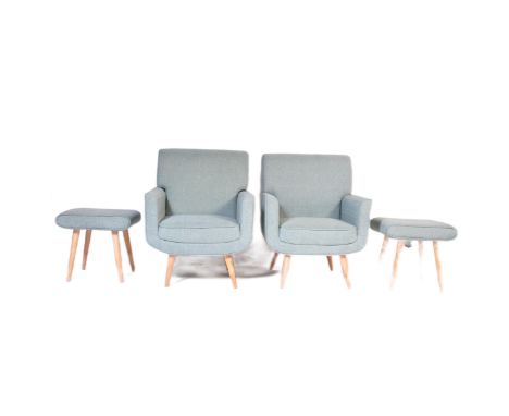 A pair of contemporary light blue fabric padded back and seat rests lounge chairs raised on beech splayed supports with match