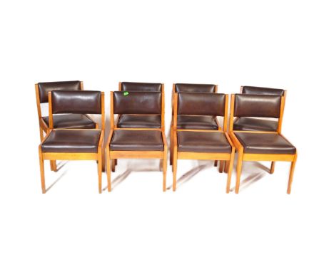 A set of eight retro vintage mid 20th century black faux leather &amp; teak frame dining chairs. Each chair having a padded l