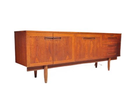 A retro vintage mid 20th century teak sideboard in the manner of G-Plan Fresco. The sideboard having a straight top over a do