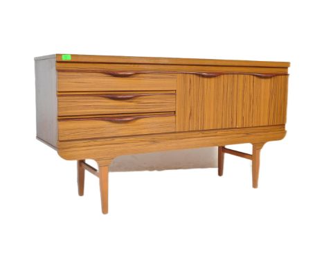 A retro vintage mid 20th century Formica teak veneered sideboard having a bank of three drawers to left &amp; twin door cupbo