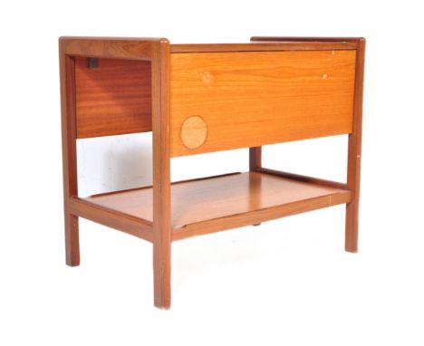 A mid 20th Century retro vintage teak wood serving trolley. With twin drop leaves rectangular form with a lower tier on uprig