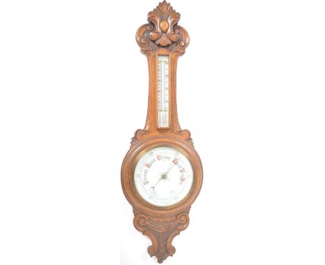 Early 20th century large oak aneroid wall barometer - thermometer banjo shaped compendium. Carved oak top with milk glass lin