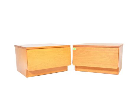 A matching pair of retro teak bedside chests / nightstands with each of low form having single blind fronted drawers. Each me