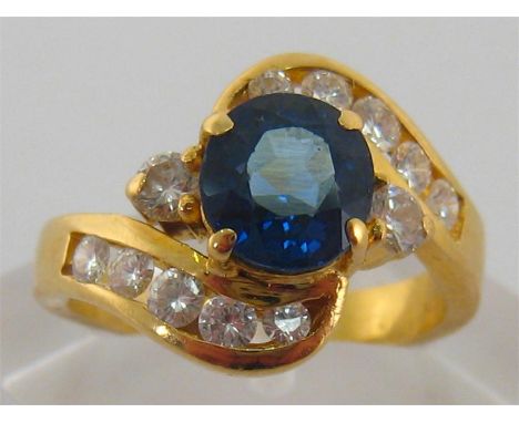 A sapphire and diamond ring, the central sapphire 7.3 x 6.7 x 5.2 mm, above brilliant set shoulders, the yellow metal (tests 