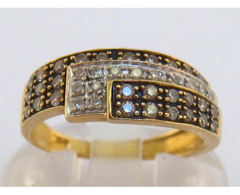 A yellow metal (tests 14 carat), diamond and enamel ring, composed of three overlapping alternately enamelled pave set panels