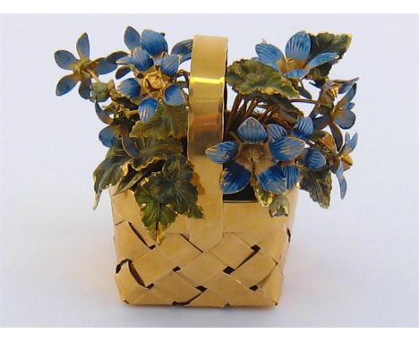 Cartier, a silver gilt and enamel ornament, circa 1950, modelled as a basket of flowers, the signed woven silver gilt basket 