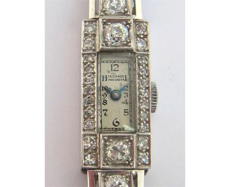 An Art Deco platinum and diamond cocktail watch by Technos, circa 1930, the rectangular case with a small signed silvered dia