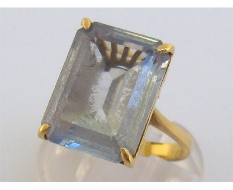 An 18 carat gold and blue topaz dress ring, the rectangular step cut stone 15.6 x 11.7mm, the shank stamped ‘750’, finger siz