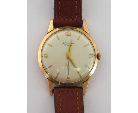 Nivada, a gentleman’s 9 carat gold manual wind dress watch, the circular silvered dial with applied gold baton and Arabic num