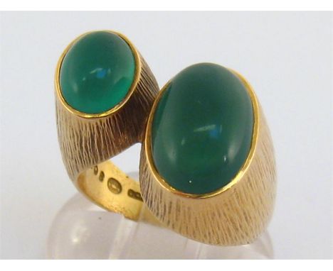 A 1960s 18 carat gold and green stone ring by Georg Jensen, design by Ibe Dahlquist, the two oval cabochon stone terminals 8.