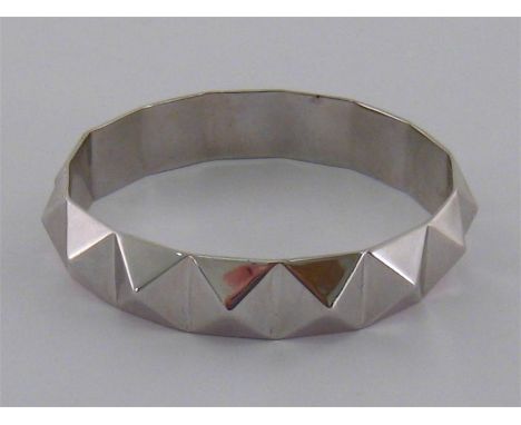 A silver bangle by Maximoi, cast with pyramidal studs, 69mm inner diameter, 33.1gms
Condition reportGood overall condition