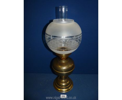 A Victorian double burner oil Lamp with frosted globe and on brass base, 20 1/2'' tall.