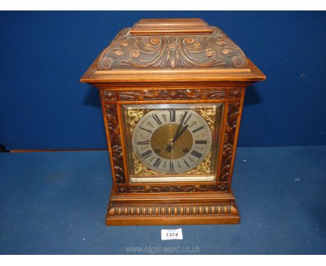 A Pine and Mahogany cased Bracket Clock/Mantle Clock having carved details with trailing flowering stems and scroll work, bra