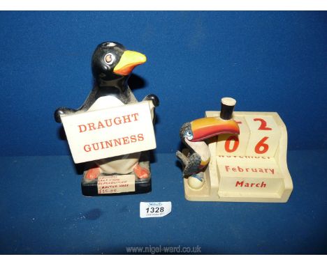 A Carltonware Guinness lamp base in the form of a penguin and a heritage Toucan perpetual calendar.