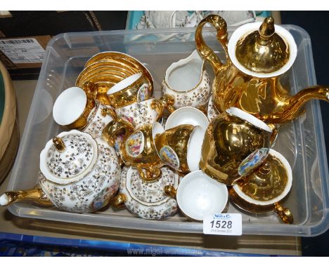 Two Czechoslovakian coffee sets; one 'Bernadotte' decorated in gold with scenes of three women in gardens, the other decorate