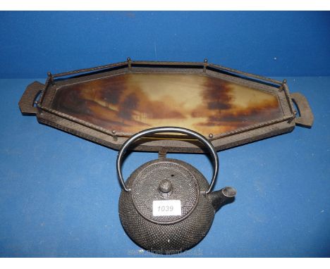 A heavy metal galleried Tray with lake scene to the centre and an oriental style cast iron Teapot.