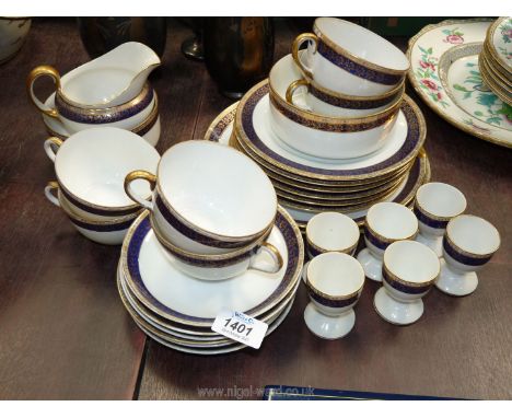 A Noritake china Teaset in white with blue and gold border to include two cake plates, six side plates, six saucers, cups, tw