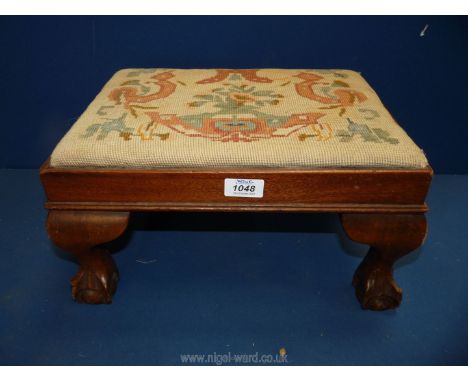 A tapestry topped Footstool with ball and claw feet, some wear, 10'' x 11'' x 8 1/4''.