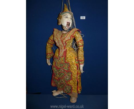 A Burmese Puppet having sequins and jewels on a glittering costume and headdress 28" long.