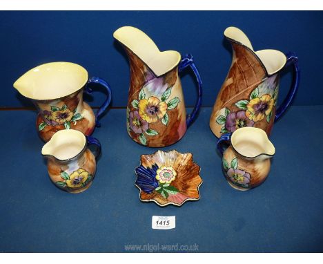 A quantity of Hollingshead and Kirkham of Tunstall jugs and pin dishes in 'Viola' pattern.