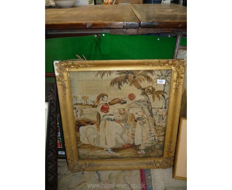 A gilt framed tapestry of a Far Eastern couple, 24 1/2'' x 23'', faded and some damage to frame