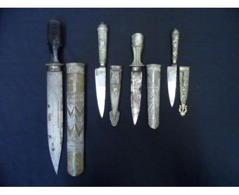TWO BHUTANESE DAGGERS AND TWO ARGENTINIAN GOUCHO KNIVES, 20TH CENTURY the first with broad blade, carved horn grip, in its de