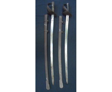 TWO ITALIAN MODEL 1860 HEAVY CAVALRY SWORDS of regulation type, each with German blade stamped 'S&K' for Schnitzler & Kirschb