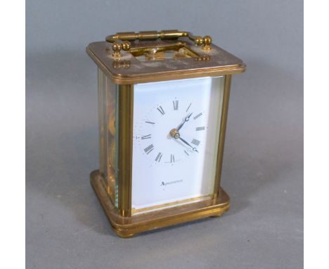 A brass cased carriage clock with lever escapement and carrying handle 