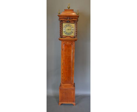 A 19th Century oak long case clock the rectangular hood with brass finials above a rectangular door, the brass dial inscribed