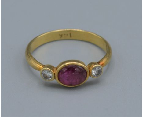 A 14ct gold ring set with a central cabachon ruby flanked by diamonds, 1.7grams, ring size K 