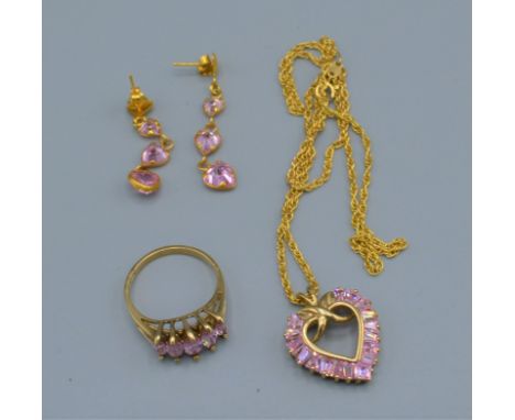 A 9ct Gold Suite of Jewellery Comprising five stone ring, a pendent with chain and a pair of drop ear studs, all set with pin