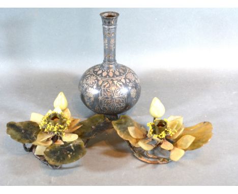 An Applied White Metal Bottleneck Vase with foliate decoration 21cms tall together with two hard stone candlesticks in the fo