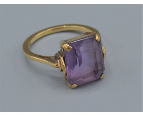 A 9ct gold dress ring set with a large rectangular Amethyst, 3.6grams, ring size L 