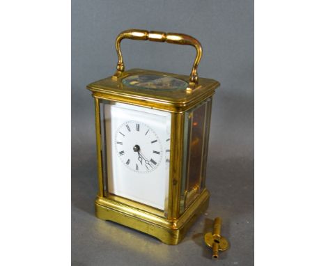 A French Brass Cased Carriage Clock, the enamel dial with Roman numerals and with lever escapement and carrying handle 13cms 