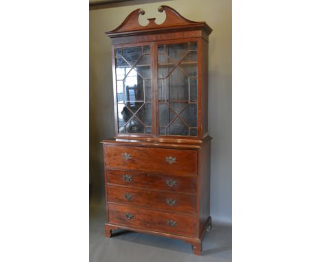 A Regency mahogany secretaire bookcase, the moulded cornice above two astragal glazed doors enclosing shelves, the lower sect