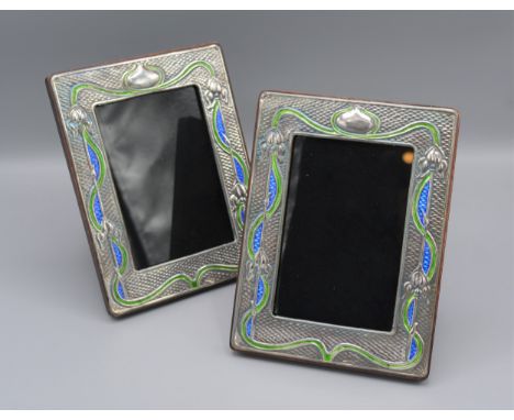 A pair of Sterling silver and enamel decorated photograph frames of rectangular form, 19.5cms X15cms 