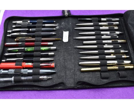 A selection of twenty three fountain, ballpoint and roller ball pens mainly Parker in a soft case