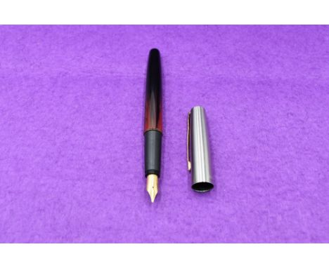 A Parker Frontier fountain pen in red and black, having silver cap with gold trim
