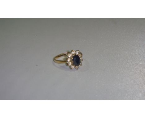 9 ct gold ring set with dark sapphire surrounded by paste