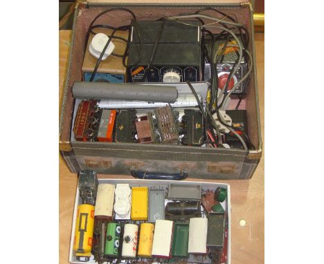 Suitcase of vintage 00 guage railway transformers, assorted coaches and rolling stock