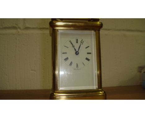 Vintage carriage clock in brass & bevelled glass case with enamelled dial
