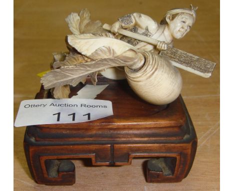 19th century carved Japanese ivory figure of a Gardener cutting a large radish with an axe 7 cms x 7 cms x 5 cms on carved ha