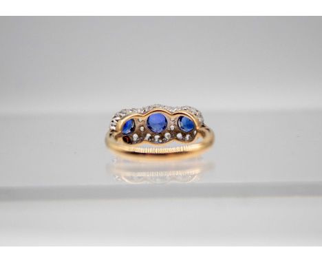 9ct Gold Synthetic Sapphire and Cubic Zirconia Cluster RingThe Ring contains three Round Brilliant Cut Sapphires. The Centre 