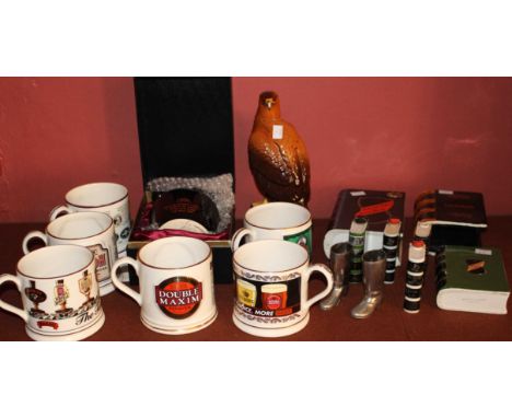 A Royal Doulton Whyte and Mackay Golden Eagle decanter, seven whisky bottles modelled as ceramic books, Wade pottery tankards